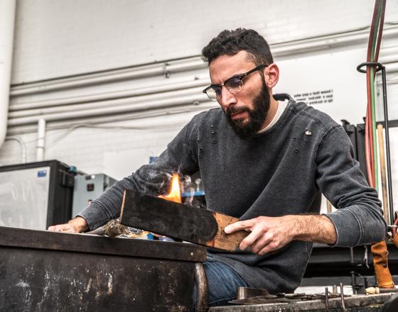 Student working with hot glass